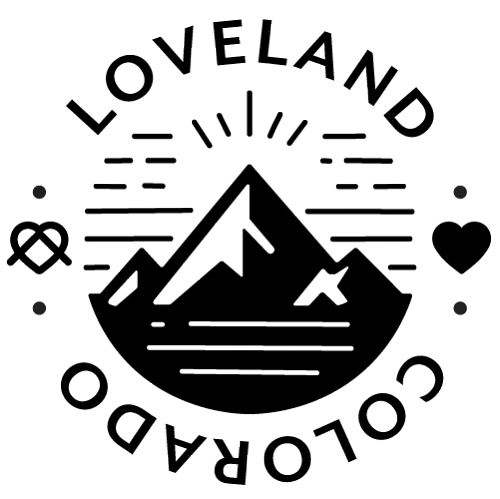 Loveland, Colorado badge: a black mountain with sun rays inside a circle of text, a heart on the right side.