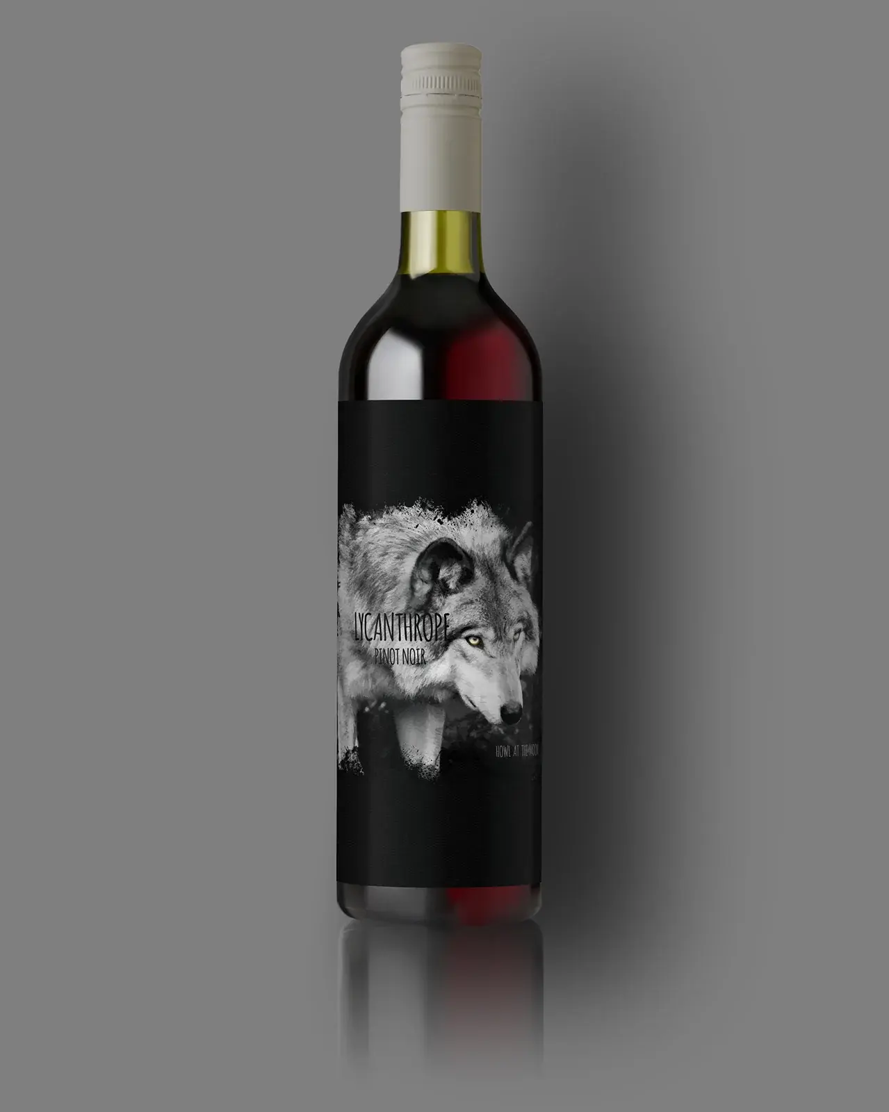 A dark wine bottle with a black and white illustrated label, lit from the side.